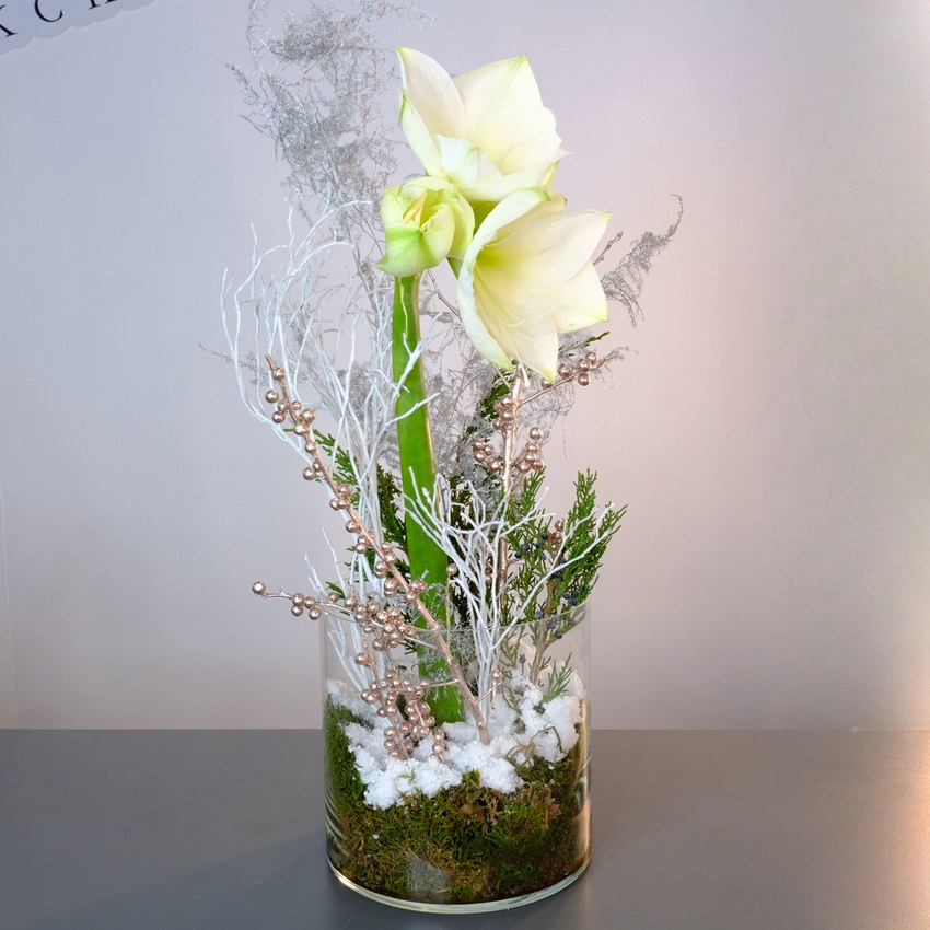 Белый амариллис в стеклянной вазе с зимним декором