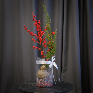 Луковица амариллиса, илекс и можжевельник в стеклянной вазе